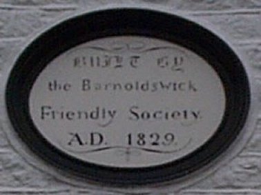 Picture of the plaque on the wall of "Quaker House"