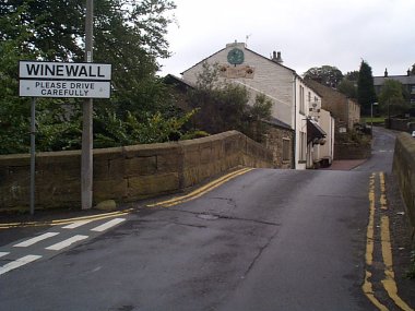 Picture of the sign and bridge going into Winewall.